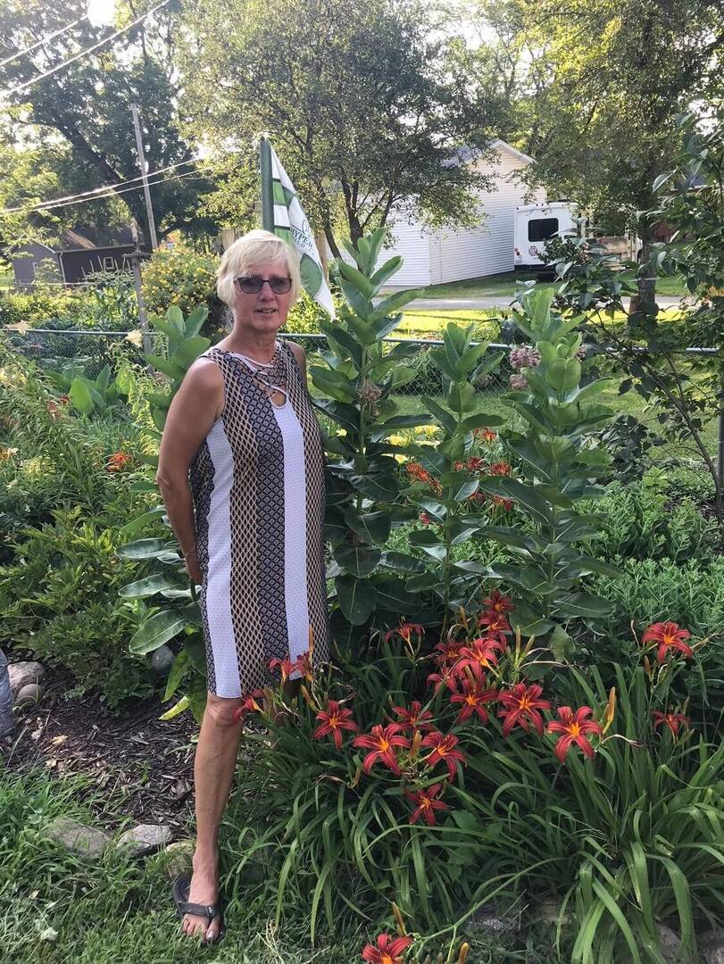 Gina posing in a garden